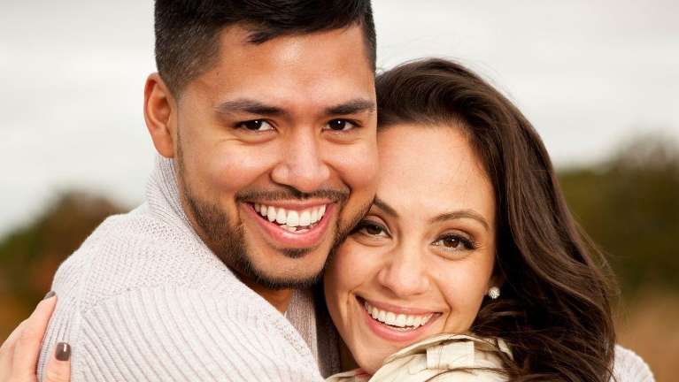 man and woman smiling with dental implants raleigh nc