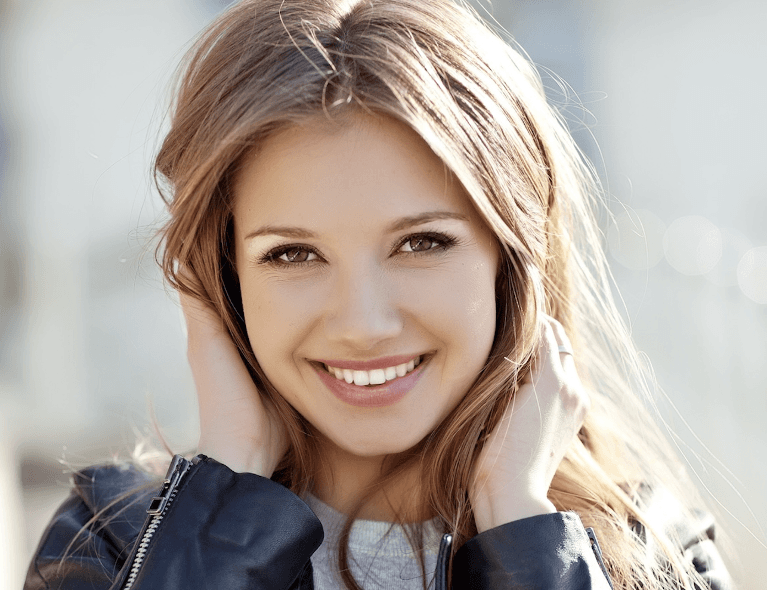 woman after getting her teeth whitened in raleigh