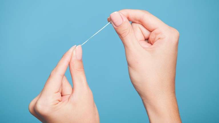 person holding floss in raleigh