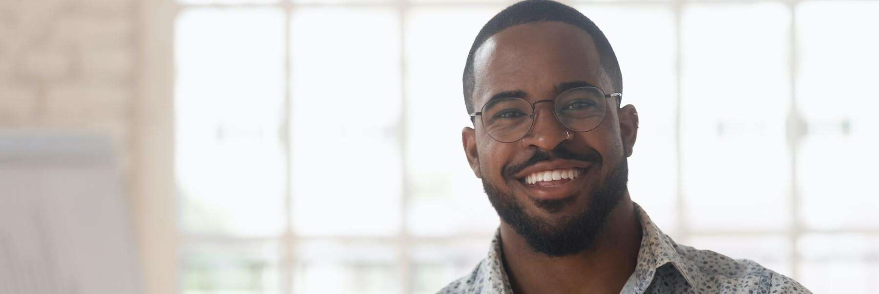 smiling man at his dentist in raleigh